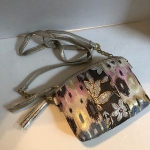 Pretty metallic bag with tassels on zipper.